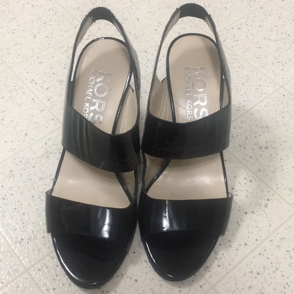 Black sling back Michael Kors heels.